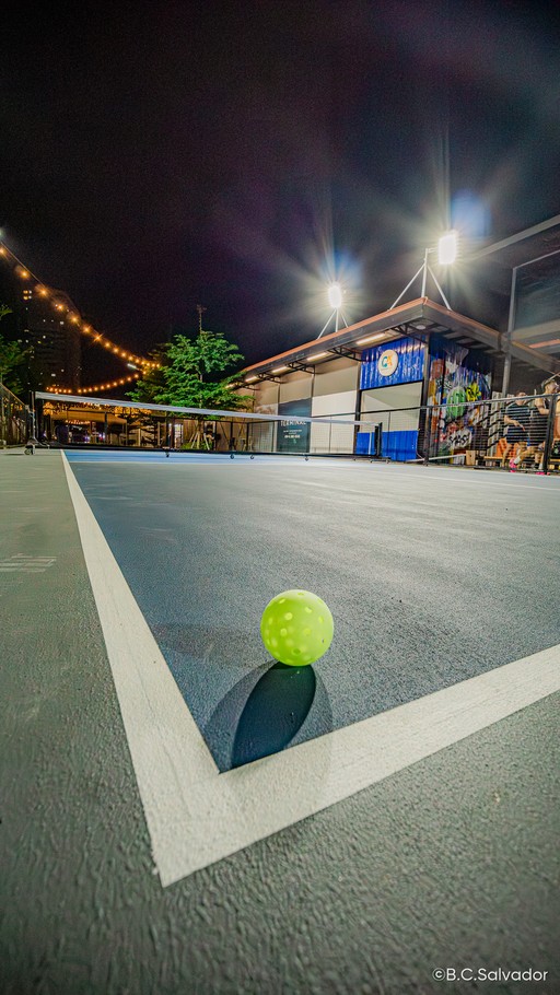 Pickleball on the court line at night